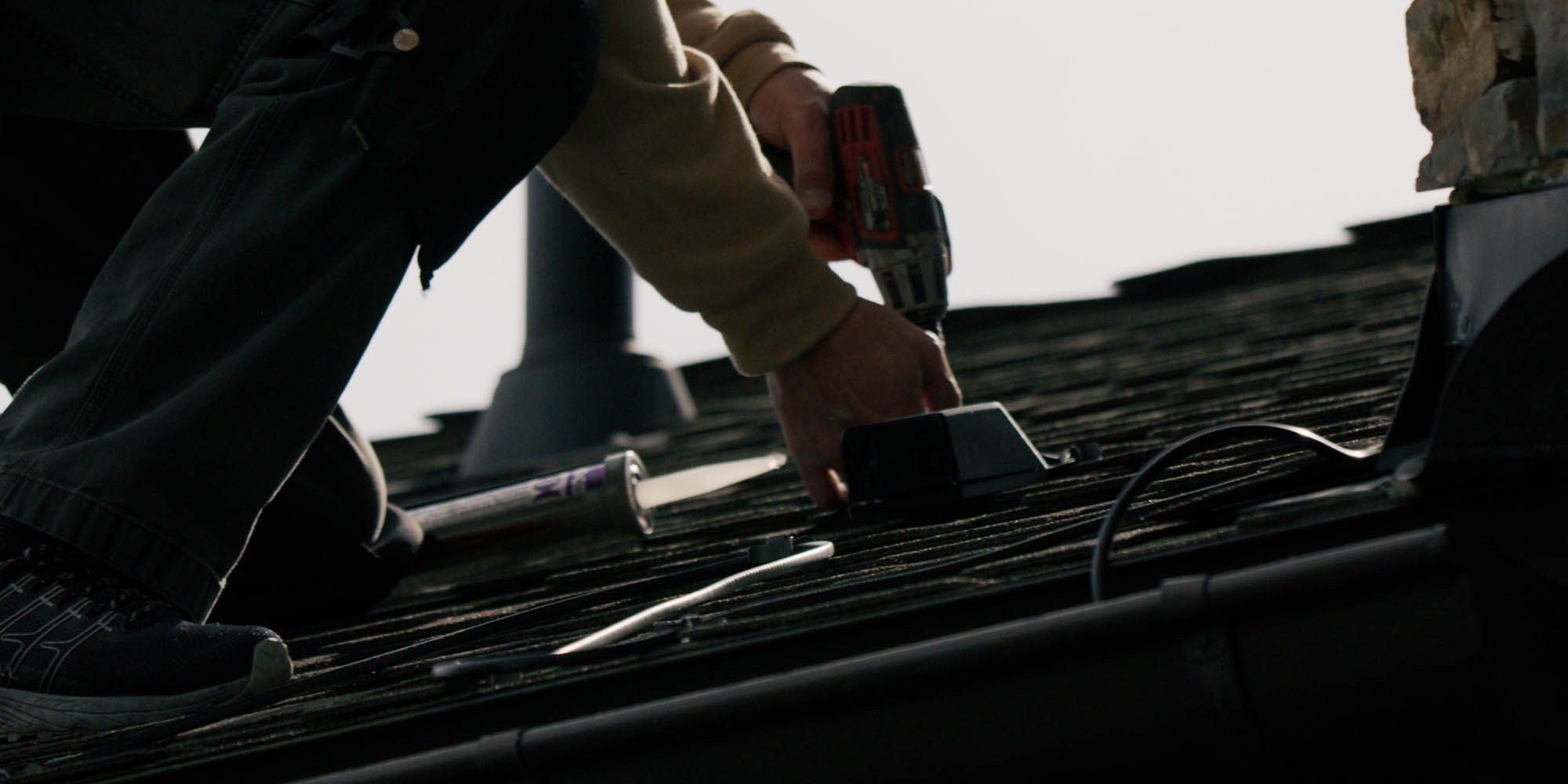 A Powder Watts camera being installed above existing rooftop heat cables